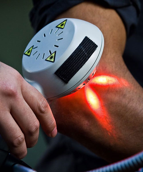 A Patient Getting Laser Therapy Treatment On His Elbow